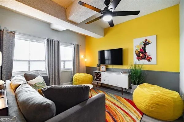 a living room with furniture and a flat screen tv