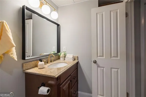 a bathroom with a sink vanity and a mirror
