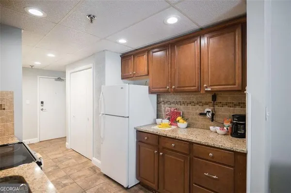 a kitchen with stainless steel appliances granite countertop a refrigerator sink and cabinets