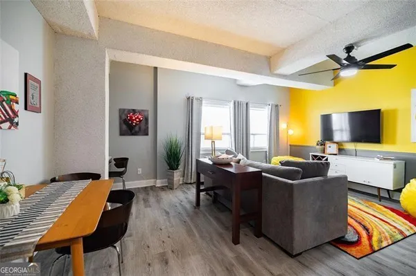 a living room with furniture and a flat screen tv