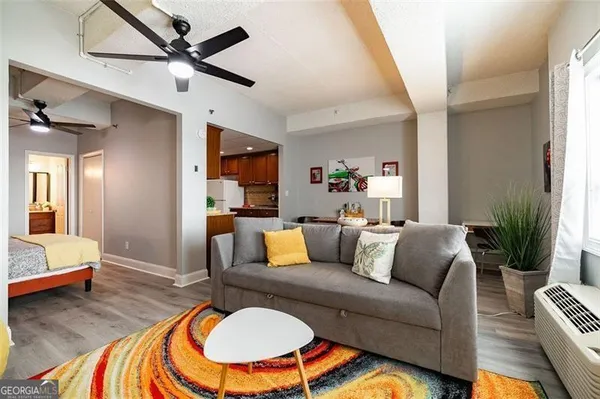 a living room with furniture and a dining table