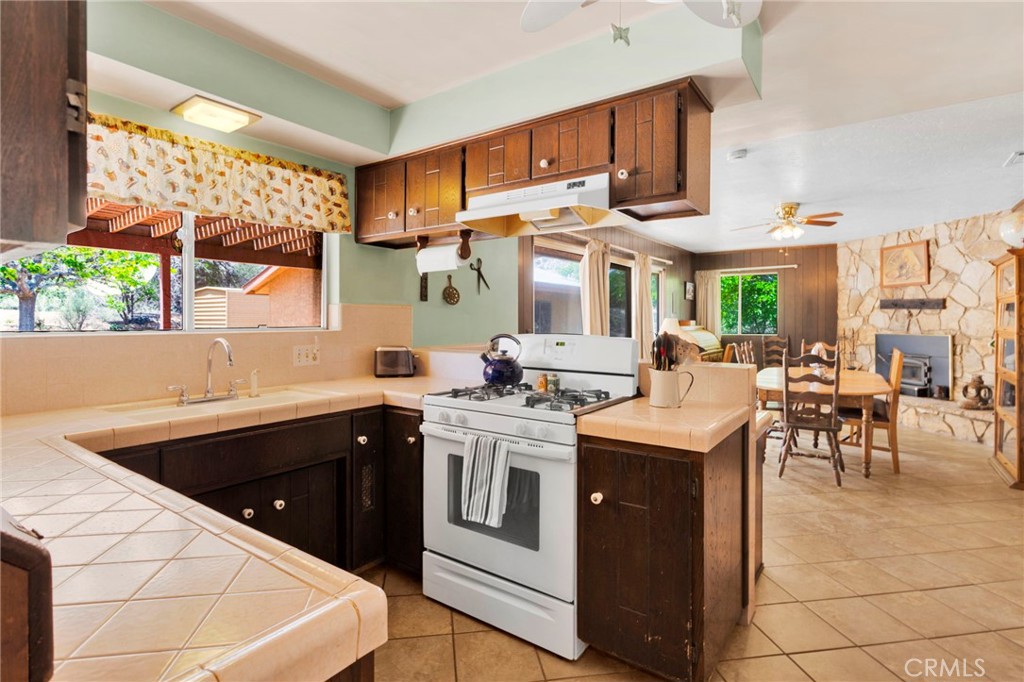 5500 Oil Well Road Phelan, CA 92371 - Photo 6 of 65 a kitchen with a sink stove and cabinets