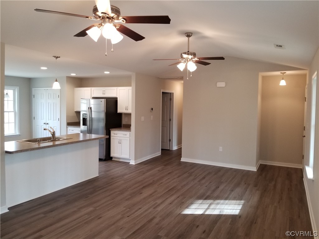 319 Hawkins Farm Road Bumpass, VA 23024 - Photo 6 of 11 an open kitchen view with wooden floor and a ceiling fan