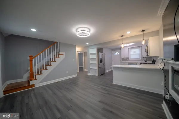 a view of a hallway with wooden floor
