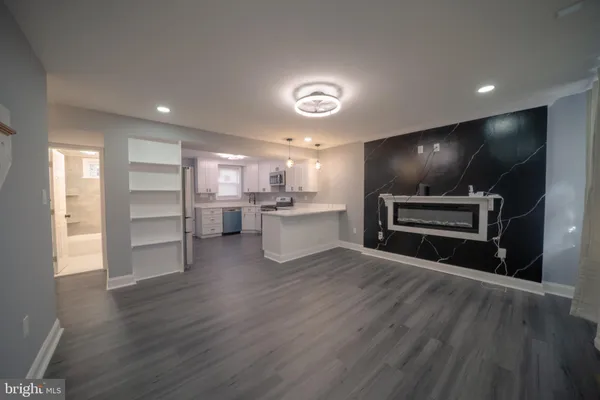 a view of kitchen and refrigerator with wooden floor