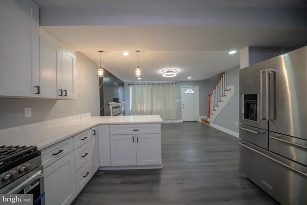 a large kitchen with cabinets and stainless steel appliances