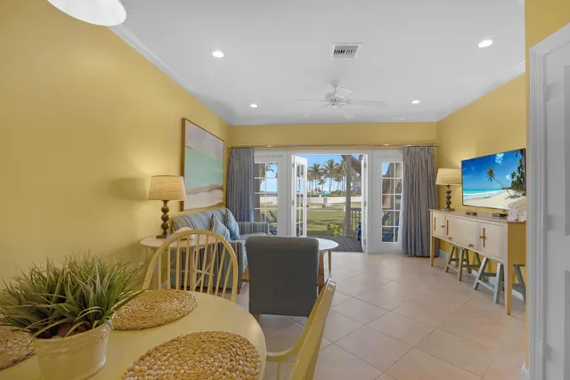 a living room with furniture floor to ceiling window and a floor to ceiling window