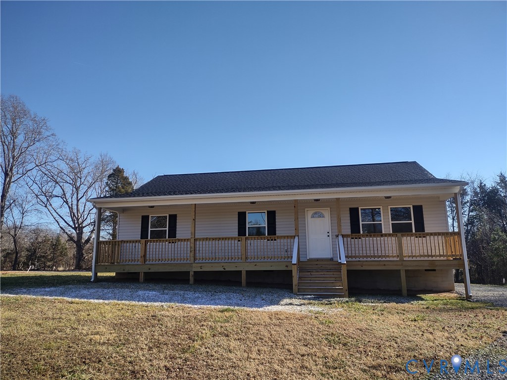 Ranch-style house with covered porch, a shingled r