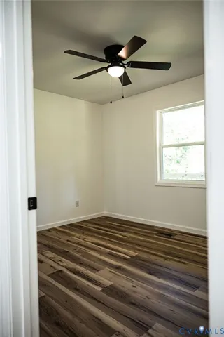 a view of room with window and ceiling fan