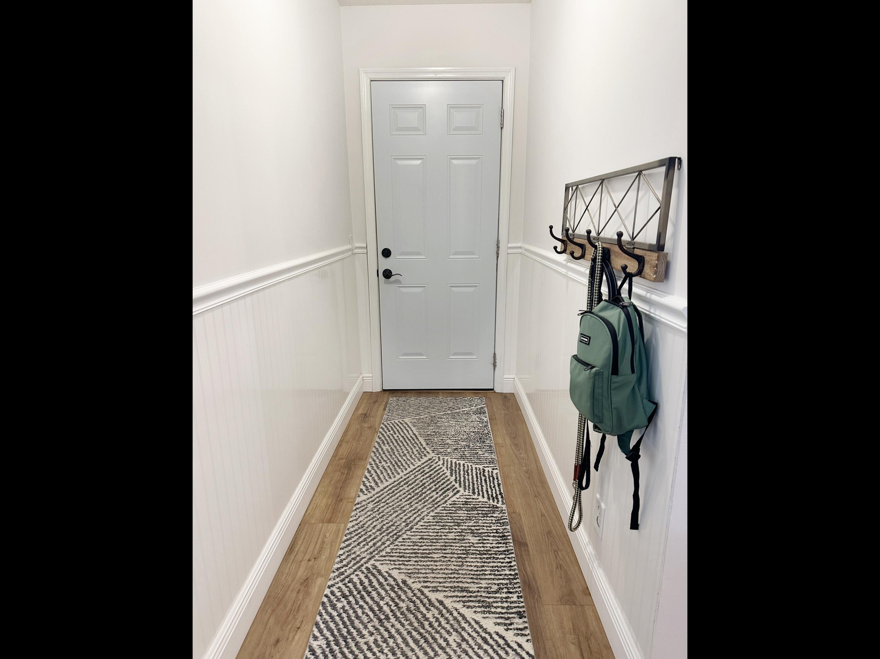2484 Southwest Century Way Stuart, FL 34997 - Photo 43 of 56 Hallway to Garage