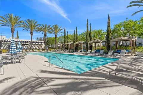 a view of a swimming pool with a table and chairs