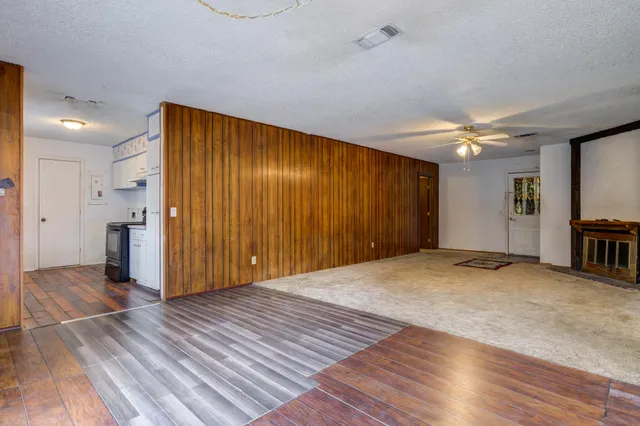 a view of a house with yard and a tree
