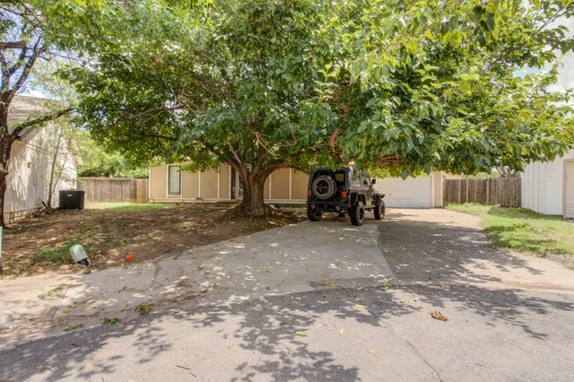 a view of an empty room with a fireplace and a window