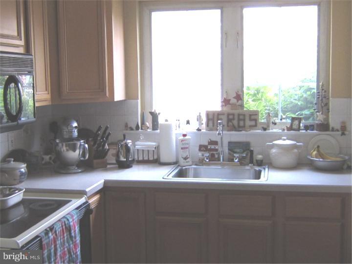 524 Paddock Road Havertown, PA 19083 - Photo 14 of 15 a kitchen with kitchen island granite countertop a sink and a counter top space