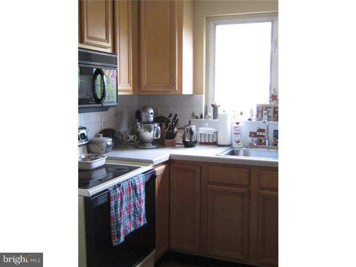 524 Paddock Road Havertown, PA 19083 - Photo 9 of 15 a kitchen with stainless steel appliances a sink and cabinets