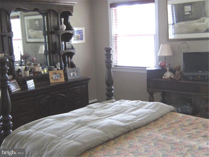 524 Paddock Road Havertown, PA 19083 - Photo 10 of 15 a bedroom with a bed and wooden floor