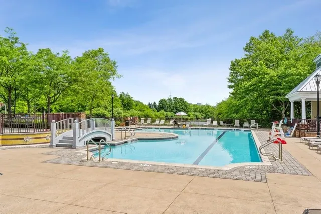 an outdoor space with pool and furniture