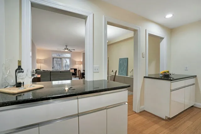 a kitchen with granite countertop a sink and cabinets