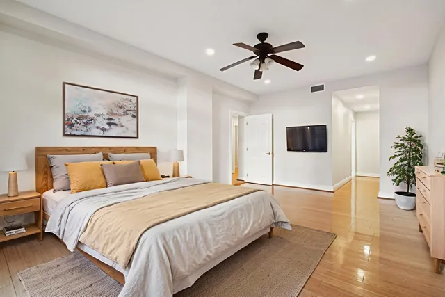 a bedroom with a large bed and a flat screen tv