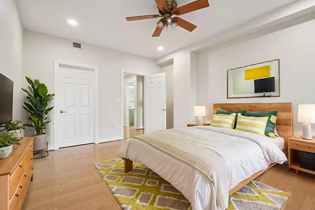 a bedroom with a bed and a potted plant