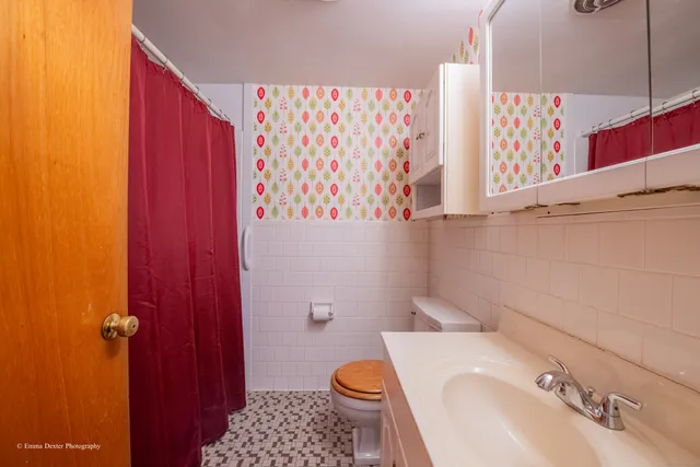 a bathroom with a sink toilet and shower