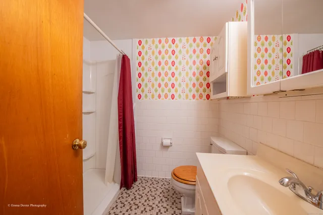 a view of an empty room with window wooden floor and cabinet