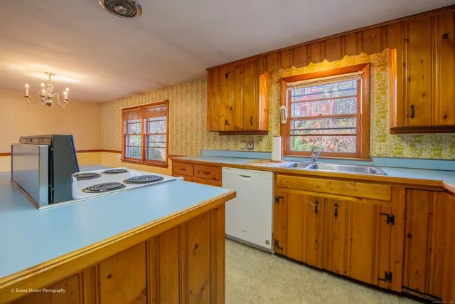 a kitchen that has a stove and a wooden floor