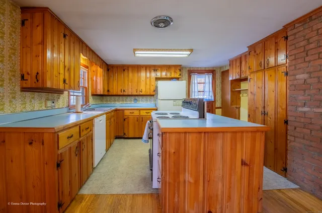 a kitchen with a stove a sink and a refrigerator