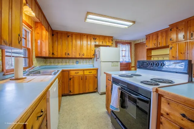 a view of a kitchen with furniture and wooden floor