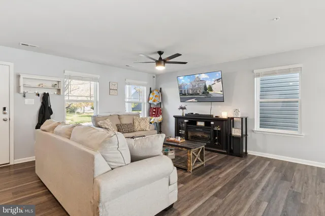 a living room with furniture a table and a window