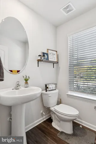 a bathroom with a sink toilet mirror and tub