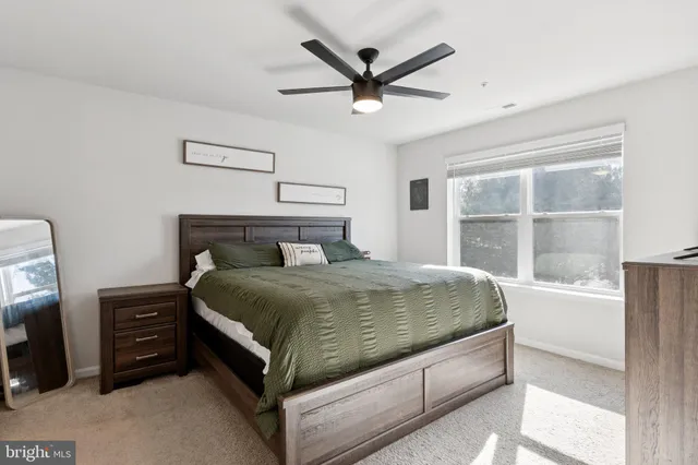 a bedroom with a bed and a large window