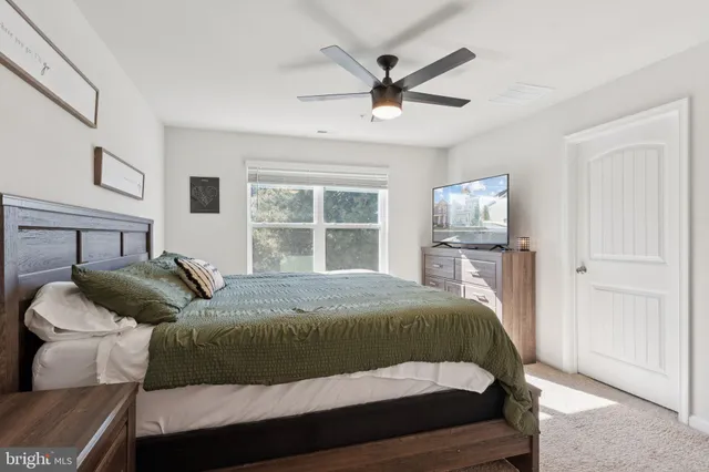 a bedroom with a large bed and a window
