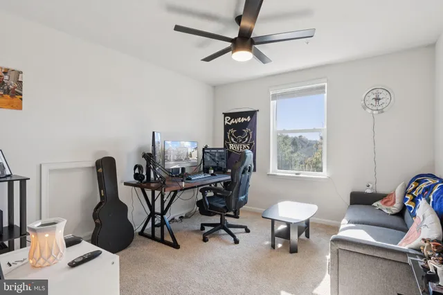 a view of a workspace with furniture and a window