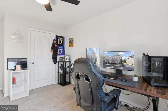 a workspace with furniture and fan