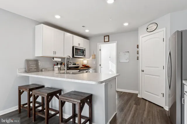 a kitchen with stainless steel appliances a refrigerator stove microwave and cabinets