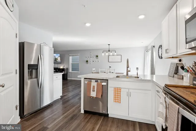 a kitchen with stainless steel appliances granite countertop a white stove top oven and refrigerator