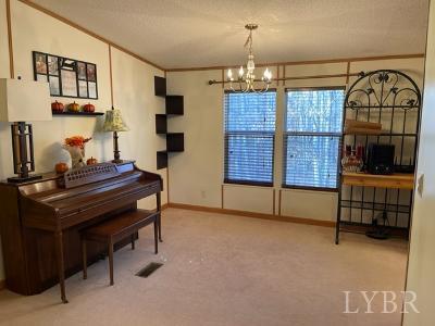 514 West Lake Road Spout Spring, VA 24593 - Photo 13 of 19 a room with furniture and a chandelier
