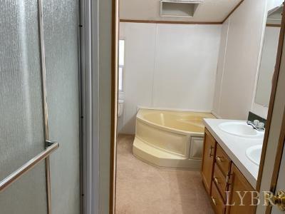 514 West Lake Road Spout Spring, VA 24593 - Photo 18 of 19 a bathroom with a sink toilet and tub