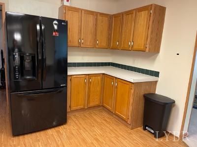 514 West Lake Road Spout Spring, VA 24593 - Photo 7 of 19 a kitchen with a refrigerator and cabinets