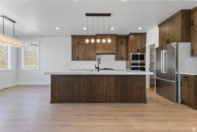 710 East Mountain Road North Ogden, UT 84414 - Photo 7 of 36 Kitchen with a center island with sink, decorative light fixtures, recessed lighting, stainless steel appliances, and light wood finished floors