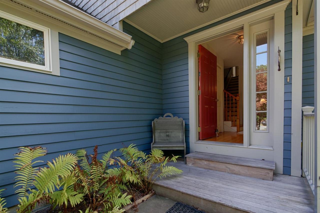 188 Abbey Gate Road Cotuit, MA 02635 - Photo 1 of 23 a front view of a house with a garden