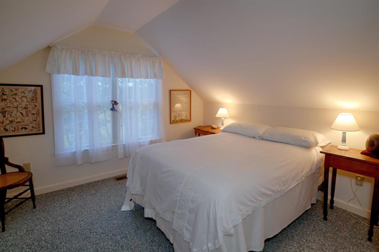 188 Abbey Gate Road Cotuit, MA 02635 - Photo 15 of 23 a spacious bedroom with a bed and a lamp