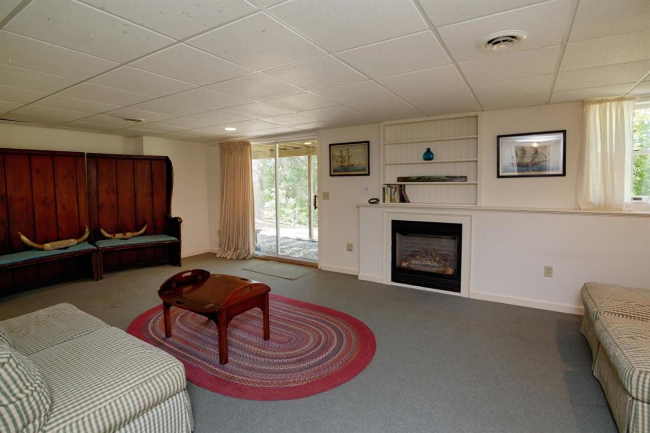 188 Abbey Gate Road Cotuit, MA 02635 - Photo 17 of 23 a living room with furniture a fireplace and a window