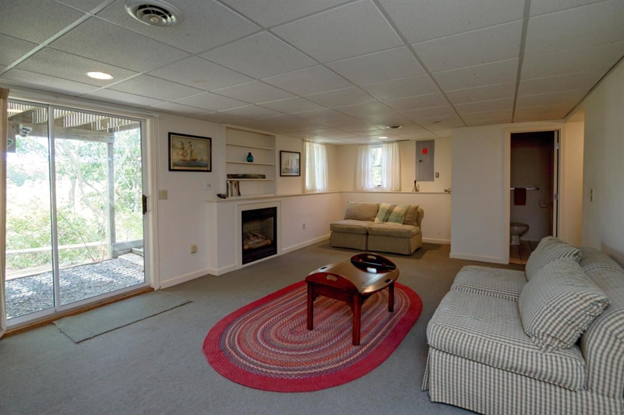 188 Abbey Gate Road Cotuit, MA 02635 - Photo 18 of 23 a living room with furniture and a fireplace