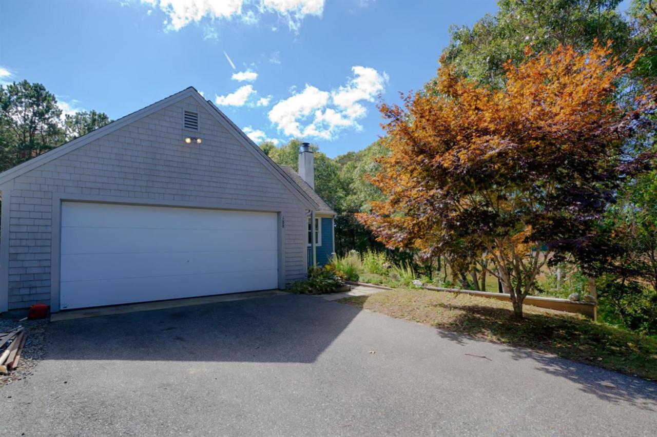 188 Abbey Gate Road Cotuit, MA 02635 - Photo 19 of 23 a front view of a house with a yard and garage