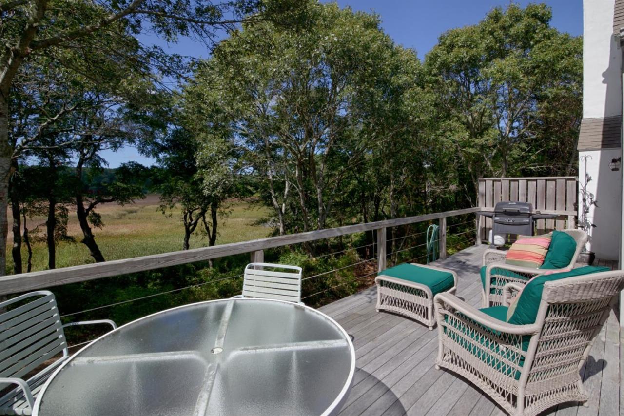 188 Abbey Gate Road Cotuit, MA 02635 - Photo 3 of 23 a balcony with wooden floor and outdoor seating
