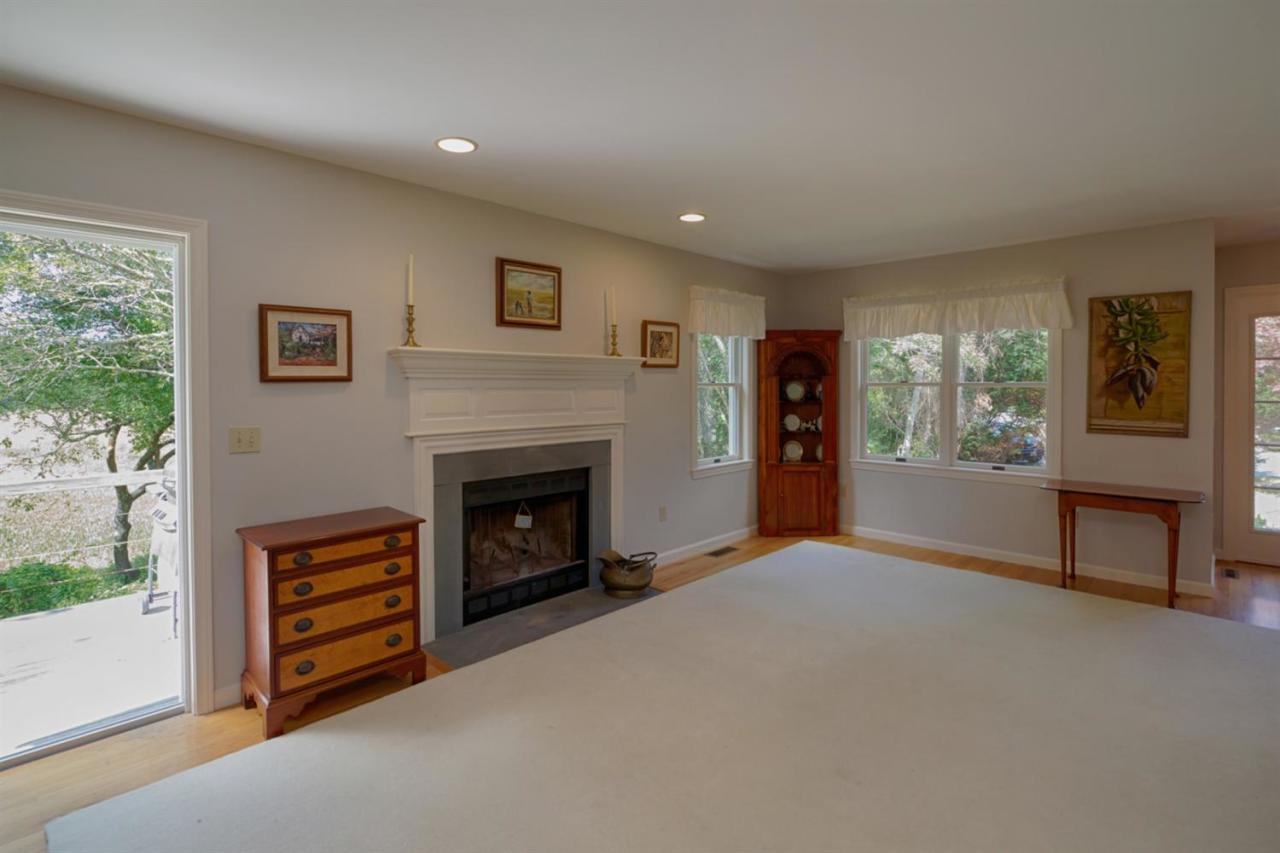 188 Abbey Gate Road Cotuit, MA 02635 - Photo 6 of 23 a view of an empty room with a fireplace and a window