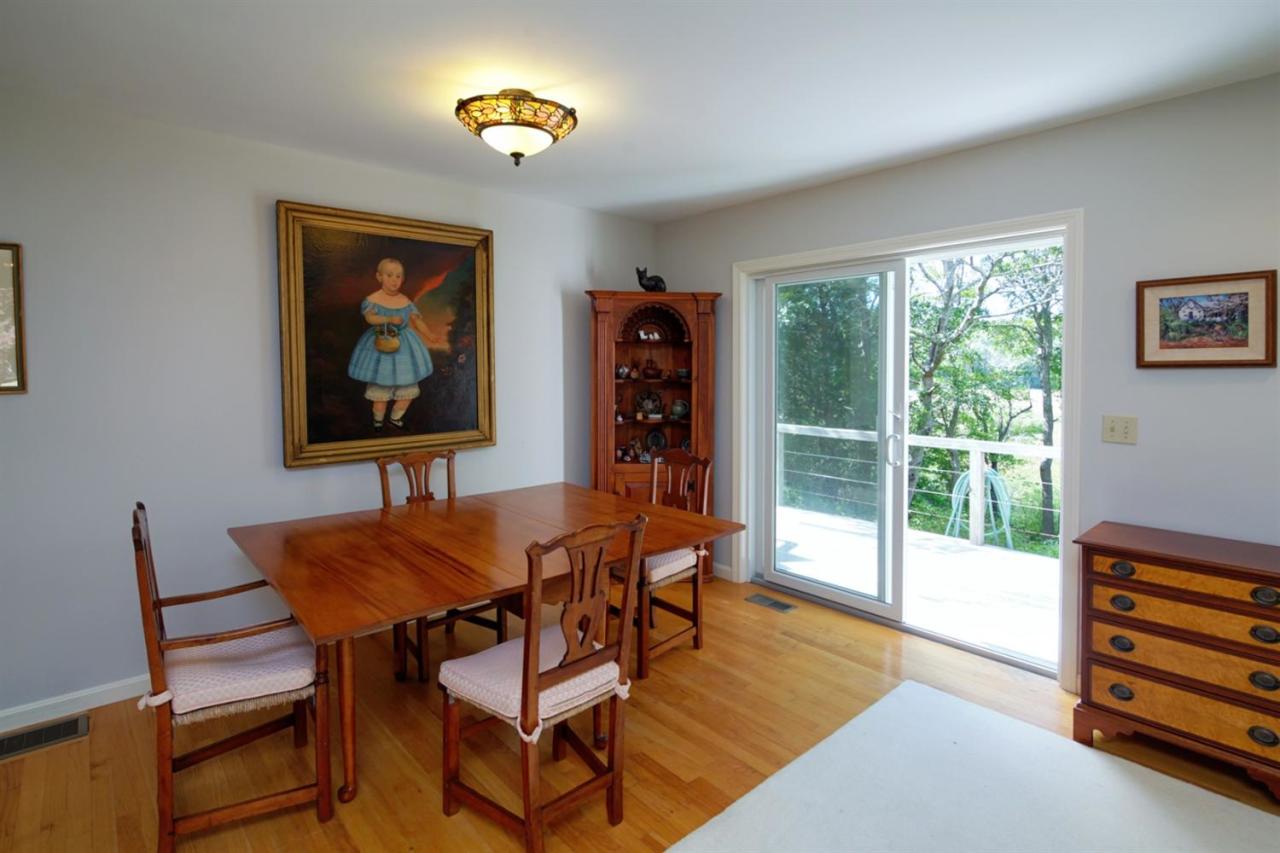 188 Abbey Gate Road Cotuit, MA 02635 - Photo 8 of 23 a dining room with furniture and a floor to ceiling window