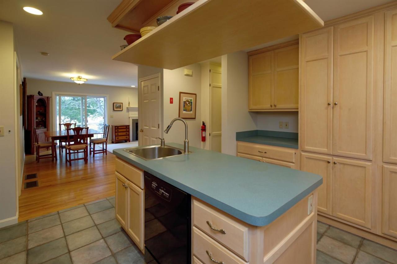 188 Abbey Gate Road Cotuit, MA 02635 - Photo 10 of 23 a kitchen with a sink appliances and cabinets